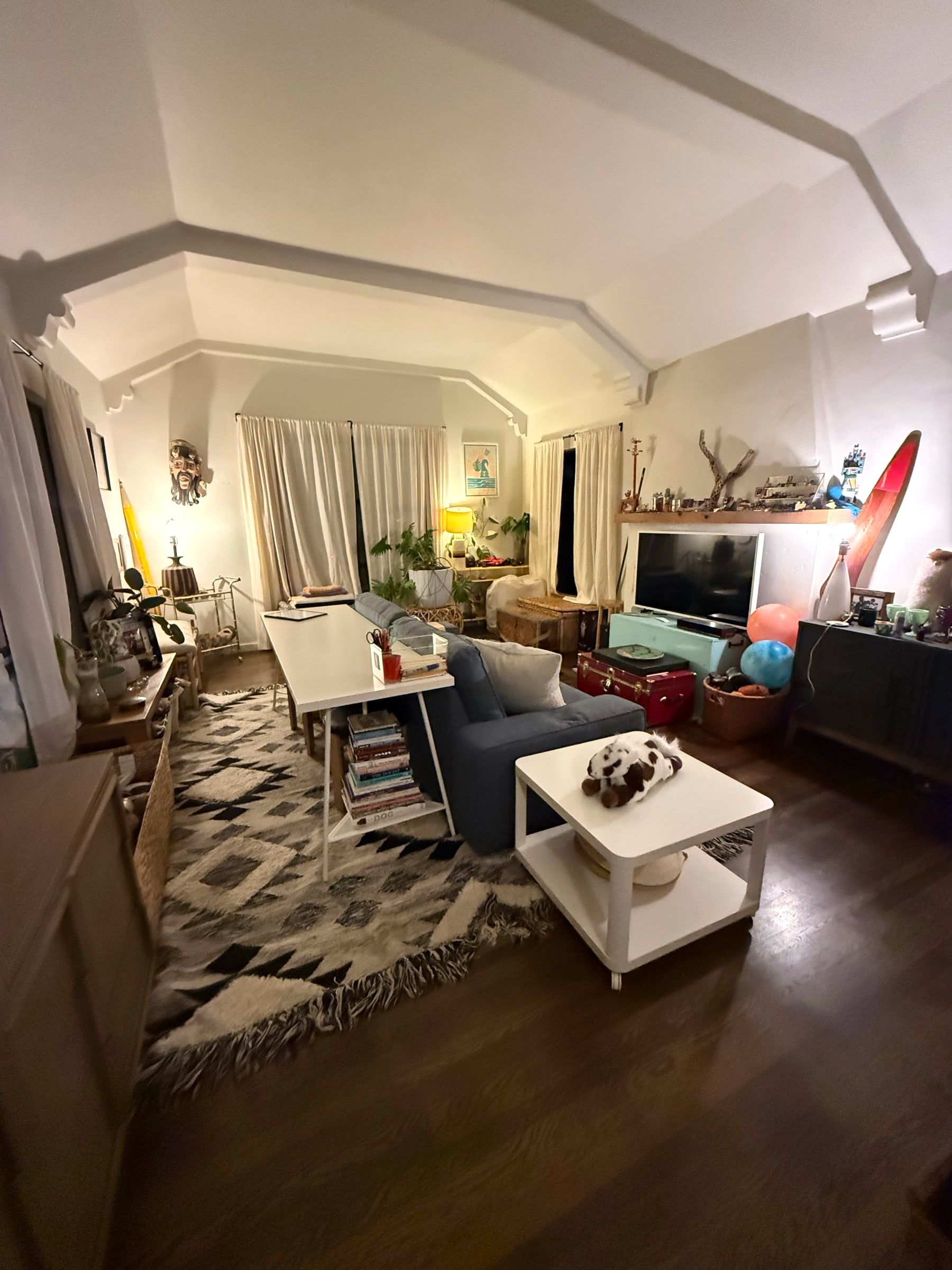 After: The same living room organized, with an open floor, rug and seating area